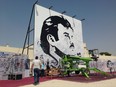 A black-and-white depiction of Qatar's emir, Sheikh Tamim bin Hamad Al Thani, attracts signatures and comments of support from residents amid a diplomatic crisis between Qatar and neighboring Arab countries in Doha, Qatar, on Monday, July 3, 2017. A group of Arab nations has extended a deadline for Qatar to respond to their list of demands in a diplomatic crisis roiling the Gulf by 48 hours, saying Kuwait's emir requested the delay as part of his efforts to mediate the dispute. (AP Photo/Maggie Hyde)