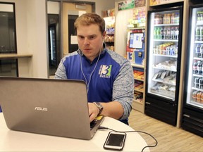 Tony Danna, vice president of international development at Three Square Market, works on his laptop in a company break room at its headquarters, Tuesday, July 25, 2017 in River Falls, Wis. The software company is offering to microchip its employees, enabling them to open doors, log onto their computers and purchase break room snacks with a simple wave of the hand. (AP Photo/Jeff Baenen)