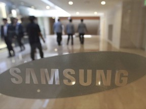 FILE - In this Oct. 12, 2016, file photo, the corporate logo of Samsung Electronics Co. is seen at its shop in Seoul, South Korea. Samsung Electronics said Tuesday, July 4, 2017 it will invest 21.4 trillion won ($19 billion) in the next four years in its memory chip and display plants in South Korea. (AP Photo/Ahn Young-joon, File)