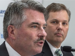 Tembec CEO James Lopez, left, responds to a question next to Paul Boynton, chairman, president and CEO of Rayonier Advanced Materials, during a news conference in May in Montreal.