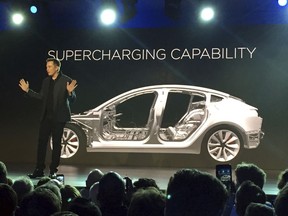 Tesla CEO Elon Musk speaks at the unveiling of the Model 3 at the Tesla Motors design studio in Hawthorne, Calif.