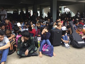 Myanmar workers wait before leaving Thailand at Mae Sot Immigration office in Tak province Thailand, Monday, July 3, 2017. Fearful that Thailand's new labor rules will get them into trouble, tens of thousands of migrant workers are returning to neighboring Myanmar, Cambodia and Laos, causing hardship to themselves and their Thai employers. (AP Photo/Chiravuth Rungjamratratsami)