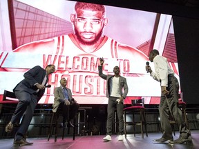Chris Paul waves to fans after being introduced as the newest member of the Houston Rockets Friday, July 14, 2017, in Houston. The nine-time All-Star was traded from the Los Angeles Clippers late last month. Joining Paul on stage, from left to right, are Rockets announcer Craig Ackerman, coach Mike D'Antoni and basket hall of fame member Calvin Murphy. (AP Photo/David J. Phillip)