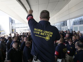 Brian Parker, strategic action coordinator for the Transport Workers Union, addresses a crowd before a protest march at Dallas/Fort Worth International Airport in Grapevine, Texas, Wednesday, July 26, 2017. Protesters from a coalition of different unions participated in a picket against American Airlines and its ongoing contract negotiations with ground workers. (AP Photo/LM Otero)
