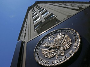 FILE - In this June 21, 2013, file photo, the seal affixed to the front of the Department of Veterans Affairs building in Washington. A House committee unveiled a disputed plan July 21, 2017, to allow the Department of Veterans Affairs to shift $2 billion from other programs to cover a sudden budget shortfall that could threaten medical care for thousands of patients in the coming weeks.(AP Photo/Charles Dharapak, File)