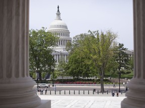 FILE - In this May 5, 2014, file photo, the Capitol building is seen through the columns on the steps of the Supreme Court in Washington. Republicans in Washington have been clamoring for years to address the long-term financial problems of Social Security and Medicare. On July 13, the trustees who oversee the programs are scheduled to issue their annual warning about the finances of the federal government's two largest benefit programs.(AP Photo/Carolyn Kaster, File)