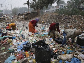 FILE - In this Jan. 21, 2016 file photo, Indian rag pickers look for reusable materials at a garbage dump littered with polythene bags in Lucknow, India. A new massive study finds that production of plastic and the hard-to-breakdown synthetic waste is soaring in huge numbers. The study says since 1950, industry has made more than 9 billion tons of plastics. That's enough to cover the entire country of Argentina ankle deep in the stuff.   (AP Photo/Rajesh Kumar Singh)