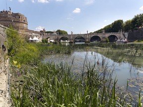 A view of the Tiber River, whose level is low due to the drought, during a warm and sunny day in Rome, Wednesday, July 26, 2017. Scarce rain and chronically leaky aqueducts have combined this summer to hurt farmers in much of Italy and put Romans at risk for drastic water rationing as soon as this week. (AP Photo/Domenico Stinellis)