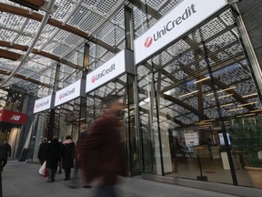 FILE -- In this Dec. 13, 2016, file photo, people walk in front of the entrance of the UniCredit tower at the Porta Nuova business district in Milan, Italy. Italy's largest bank, Unicredit, says accounts of some 400,000 customers in Italy have been hacked. The bank said in a statement Wednesday, July 26, 2017, that the hackers accessed only accounts related to personal loans, and that it was breached through an unidentified external commercial partner. (AP Photo/Luca Bruno)