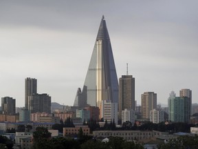 The 105-story pyramid shaped Ryugyong hotel towers over residential buildings in Pyongyang, North Korea. The building recently had a sign declaring North Korea is a leading rocket power.