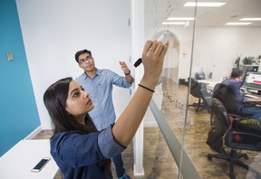 Rituparna (Ritu) Panda (left) and Sharoon Thomas write out plans in their offices.