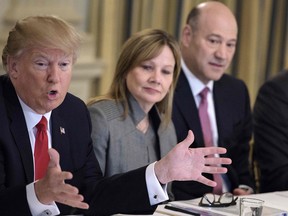 Mary Barra, CEO of General Motors, and Gary Cohn, president of Goldman Sachs, listen to President Donald Trump at a policy and strategy forum in February. Trump announced Wednesday he was scrapping two business advisory councils in the wake of several high-profile resignations in protest over his comments on a white supremacist rally in Virginia that turned violent.