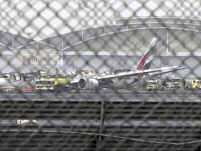 FILE- In this Wednesday, Aug 3, 2016 file photo, a damaged Boeing 777 is seen at the Dubai airport after it crash-landed, in Dubai, United Arab Emirates. Investigators said Sunday no mechanical issues affected an Emirates flight before it crash landed in Dubai and burst into flames last year, as their probe continues to look at "human performance factors" around the inciden. (AP Photo/Jon Gambrell, file)