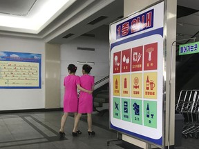 In this Monday, June 19, 2017, photo, staff members walk toward the escalators of the Potonggang department store in Pyongyang, North Korea. Three generations into Kim Jong Un's ruling dynasty, markets have blossomed and a consumer culture is taking root. (AP Photo/Wong Maye-E)