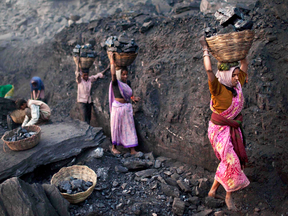 Baskets of coal scavenged illegally are carried at a mine in a village in the eastern Indian state of Jharkhand.