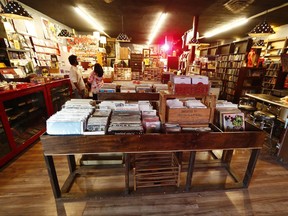 In this Sunday, Aug. 20, 2017, photo, customers pick through the records on display inside of an information cafe called Mutiny in south Denver. Shop owner Jim Norris is hoping to license his storefront as one of the nation's first legal marijuana clubs. (AP Photo/David Zalubowski)