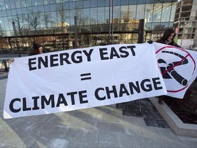 Members of Stop Energy East Halifax protest outside the library in Halifax on Monday, Jan. 26, 2015. In a decision cheered by environmentalists but considered a setback by the oil industry, Canada's national energy regulator says it will allow wider discussion of greenhouse gas emission issues in upcoming hearings for the Energy East Pipeline. THE CANADIAN PRESS/Andrew Vaughan