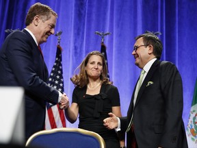 U.S. Trade Representative Robert Lighthizer, left, shakes hands with Canadian Foreign Affairs Minister Chrystia Freeland, accompanied by Mexico's Secretary of Economy Ildefonso Guajardo Villarreal, after they spoke at a news conference, Wednesday, Aug. 16, 2017.