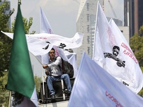 A man on the top of a van waves a flag during a farmers' protest in Mexico City on Aug. 7, 2017. A round of NAFTA negotiations is about to start in a country that's served as Donald Trump's political whipping boy. Increasingly, there are indications Mexico is willing to whip back. THE CANADIAN PRESS/AP, Gustavo Martinez Contreras