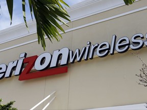 This Friday, Aug. 11, 2017, photo shows a Verizon wireless sign in Miami. Verizon is raising the price on its unlimited plan while introducing a slightly cheaper, more limited version of it as wireless carriers battle each other for customers. (AP Photo/Alan Diaz)