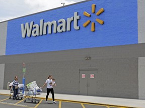 In this Thursday, June 1, 2017, photo, customers walk out of a Walmart store in Hialeah Gardens, Fla. Wal-Mart Stores, Inc. reports earnings, Thursday, Aug. 17, 2017. (AP Photo/Alan Diaz)