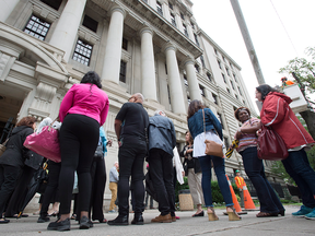 Disgruntled Sears employees gather at the Ontario Superior Court in Toronto on July 13. Sears laid off 2,900 employees without severance in June.