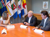 Foreign Affairs Minister Chrystia Freeland, left, sits with Unifor President Jerry Dias, right, and United Auto Workers President Dennis Williams in Toronto
