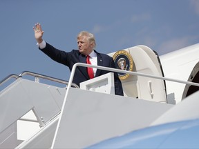 President Donald Trump waves as he boards Air Force One at Andrews Air Force Base, Md., Friday, Aug. 4, 2017, en route to New Jersey to begin his summer vacation at his Bedminster golf club. (AP Photo/Evan Vucci)