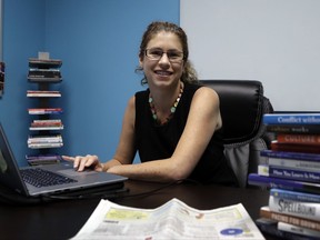 In a July 27, 2017, photo, Becky Robinson poses for a picture in her marketing company office in Lambertville, Mich. As small businesses keep hiring, many owners discover that being a do-it-yourself human resources manager is the wrong job for them. Robinson handled payroll, hiring and other HR needs when she started her marketing company, Weaving Influence, five years ago. But during periods when she focused on HR, the company's revenue took a dip. She realized she needed to keep her focus and turn those tasks over to a director of operations and an HR consultant. (AP Photo/Carlos Osorio)