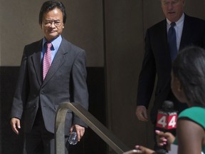 FILE - In this Sept. 9, 2016, file photo, Volkswagen engineer James Robert Liang, left, leaves court, in Detroit, after pleading guilty to one count of conspiracy in the company's emissions cheating scandal. U.S. prosecutors are seeking a three-year prison sentence for a Volkswagen engineer who had a key role in the company's diesel emissions scandal. Liang is scheduled to be sentenced Friday, Aug. 25, 2017, in Detroit federal court. He is one of two VW employees to plead guilty, although others charged in the case are in Germany and out of reach. (Virginia Lozano/Detroit News via AP, File)
