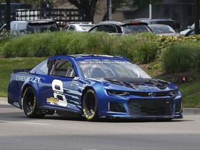 Jimmie Johnson drives the 2018 Chevrolet Camaro ZL1, a new race car for the Monster Energy NASCAR Cup Series, down Jefferson Avenue during a news conference in Detroit, Thursday, Aug. 10, 2017. The new Camaro will make its on-track debut during the 2018 Daytona 500 auto race. (AP Photo/Paul Sancya)