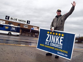 FILE - In this Nov. 4, 2014, file photo, Republican U.S. House candidate Ryan Zinke waves to supporters in Columbia Falls, Mont. The campaign's recreational vehicle, shown in the background, was recently sold to a Montana legislator up for a key post in the U.S. Interior Department, now headed by Zinke. The transaction is prompting questions about the appropriateness of the sale because of the $25,000 selling price, which is about half of the typical selling price for a similar motorhome in good condition. (Greg Lindstrom/Flathead Beacon via AP, File)