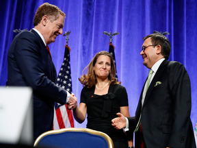 Chrystia Freeland, Canada's minister of foreign affairs (center) speaks with Bob Lighthizer, U.S. trade representative (left) and ldefonso Guajardo Villarreal, Mexico's secretary of economy (right).