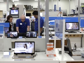 In this Tuesday, May 23, 2017, photo, employees assist a customer with a computer at Best Buy in Cary, N.C. On Thursday, Aug. 3, 2017, the Institute for Supply Management, a trade group of purchasing managers, issues its index of non-manufacturing activity for July. (AP Photo/Gerry Broome)