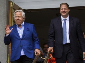 New England Patriots Chairman and CEO Robert Kraft, left, and Gov. Chris Sununu appear in front of the State House for a launch of a new Patriots lottery scratch ticket game in Concord, N.H., on Tuesday, Aug. 29, 2017. The game, which is available only in New Hampshire in 1,200 stores starting Tuesday, features four, $100,000 grand prizes and the chance to enter a series of second-chance drawings to win Patriot tickets. Other prizes range from $5 to $100. (Elizabeth Frantz/Concord Monitor via AP)