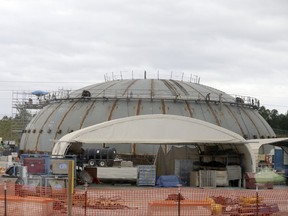 FILe - In this Sept. 16, 2016 file photo, a cap for a containment building for the V.C. Summer Nuclear Station is shown near Jenkinsville, S.C., during a media tour of the facility.  South Carolina's utilities are abandoning two partly-built nuclear reactors. And they want permission to charge customers another $5 billion to cover their costs. An environmentalist says that money could have gone to renewable energy. Others say nuclear is key to cooling the planet and won't exist if the federal government doesn't finance it. (AP Photo/Chuck Burton)