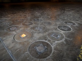 FILE - In this Nov., 20, 2013, file photo, radioactive waste, sealed in large stainless steel canisters, are stored under a five-feet of concrete in a storage building at the Savannah River Site near Aiken, S.C. South Carolina says it's filed its largest lawsuit ever against the federal government, seeking to force the U.S. Department of Energy to make good on a deal over removing plutonium from the state. The lawsuit, filed Monday, Aug. 7, 2017, seeks to recover $100 million from the agency over failing to comply with an agreement to remove one metric ton of weapons-grade materials from the Savannah River Site. (AP Photo/Stephen B. Morton, File)