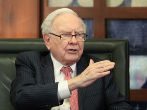 FILE - In a Monday, May 8, 2017, file photo, Berkshire Hathaway Chairman and CEO Warren Buffett speaks during an interview at the Fox Business Network in Omaha, Neb. Sempra Energy is buying Texas power transmitter Oncor for $9.45 billion in cash, wresting it away from Buffett's Berkshire Hathaway. Sempra said Monday, Aug. 21, that it will also pick up $9.35 billion of the company's debt. (AP Photo/Nati Harnik, File)