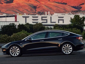 FILE - This file image provided by Tesla Motors shows the Tesla Model 3 sedan. Tesla is raising $1.5 billion as it ramps up production of its Model 3 sedan, its first mass market electric car, the company said Monday, Aug. 7, 2017. (Courtesy of Tesla Motors via AP, File)