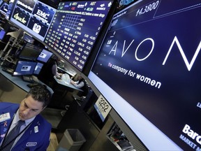 FILE - In this Tuesday, March 15, 2016, file photo, specialist Ronnie Howard works under the Avon logo on the floor of the New York Stock Exchange. Avon's CEO, Sheri McCoy, will be stepping down in March 2018, as the struggling beauty company continues to work on turning around its business. (AP Photo/Richard Drew, File)