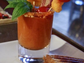 A garnished beverage made with Cheetos is shown during a press preview for a three-day pop-up restaurant featuring an all-Cheetos menu, Tuesday Aug. 15, 2017, in New York.  Celebrity chef Anne Burrell has been given the unenviable task of creating an entire menu for a pop-up restaurant based on Cheetos.  (AP Photo/Bebeto Matthews)