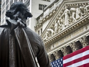 FILE - In this Wednesday, July 8, 2015, file photo, Federal Hall's George Washington statue stands near the flag-covered pillars of the New York Stock Exchange. U.S. stock indexes edged lower in early trading Tuesday, Aug. 8, 2017, pulling back from the market's most recent record highs. Health care and consumer-focused companies were among the biggest laggards. Energy stocks also fell as crude oil prices headed lower. Banks and utilities had some of the biggest gains. (AP Photo/Bebeto Matthews, File)