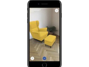 This photo provided by Ikea demonstrates Ikea's augmented reality app called IKEA Place, on an iPhone, allowing a user to superimpose virtual images over real-life settings. The app allows shoppers to see how furniture will look in their living room or other space before buying it. (Ikea via AP)