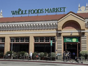 In this Monday, Aug. 28, 2017, photo, customers exit a Whole Foods Market, in Oakland, Calif. The splashy price cuts Amazon made as the new owner of Whole Foods attracted some curious customers. But whether shoppers who found cheaper alternatives to Whole Foods will come back, or those who never visited will give them a try, may help determine what kind of effect the deal has on how and where people do their grocery shopping. (AP Photo/Ben Margot)