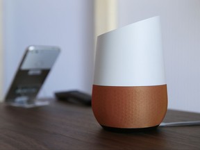 A Google Home (which is powered by Assistant) sits on display near a Pixel phone following a product event