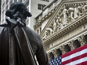 FILE - In this Wednesday, July 8, 2015, file photo, Federal Hall's George Washington statue stands near the flag-covered pillars of the New York Stock Exchange. Stocks are rising in early trading on Wall Street, Thursday, Aug. 24, 2017, after several retailers reported earnings that were far better than analysts were expecting. (AP Photo/Bebeto Matthews, File)