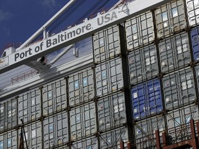 In this Oct. 24, 2016, photo, a crane hangs over a container ship at the Port of Baltimore in Baltimore. On Friday, Aug. 4, 2017, the Commerce Department reports on the U.S. trade gap for June. (AP Photo/Patrick Semansky)