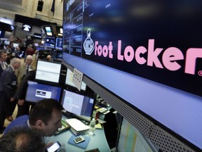 In this Wednesday, June 21, 2017, photo, the Foot Locker logo appears above a trading post on the floor of the New York Stock Exchange. Shares of sporting goods stores plummeted Friday, Aug. 18, 2017, after Foot Locker and smaller rival Hibbett Sports reported a drop in sales. Both companies also offered gloomy outlooks for the rest of the year. (AP Photo/Richard Drew)