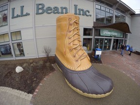 FILE - In this March 16, 2016, file photo, shoppers exit the L.L. Bean retail store in Freeport, Maine. L.L. Bean hopes to give the boot to backlogs of its most iconic product. The Maine-based retailer is expanding production to keep up with demand for its leather-and-rubber "duck boot" with a new manufacturing center that's being unveiled Thursday, Aug. 17, 2017. The company also plans to hire more than 100 additional production workers at two locations in Maine. (AP Photo/Robert F. Bukaty, File)