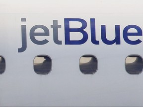 FILE - In this Jan. 20, 2011, file photo, a JetBlue logo is displayed on the side of a jet as it taxis at Boston's Logan International Airport. A JetBlue Airways plane made an emergency landing in Buffalo after a few crew members became ill on a cross-country flight. Airport police tweeted Thursday, Aug. 10, 2017, that the crew members were taken to the hospital with dizziness, and a backup plane was called in. The flight was scheduled from Boston to San Diego. (AP Photo/Stephan Savoia, File)